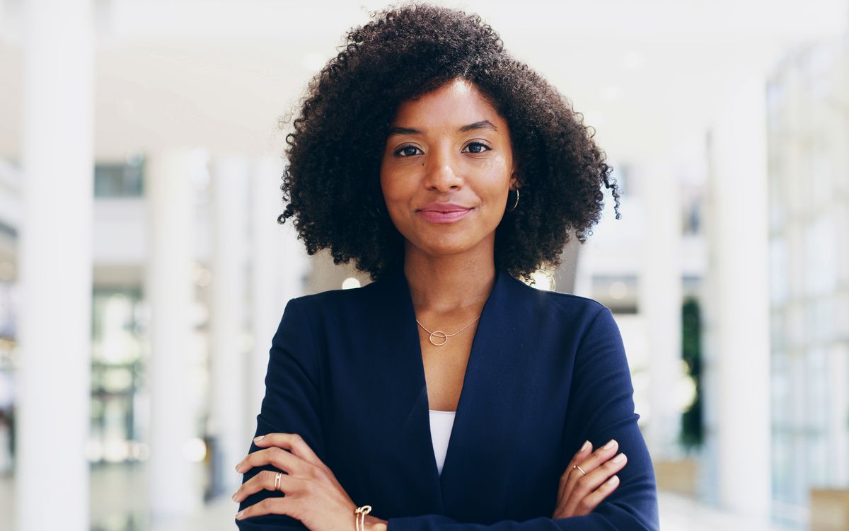 Consultant standing with arms folded in a modern office