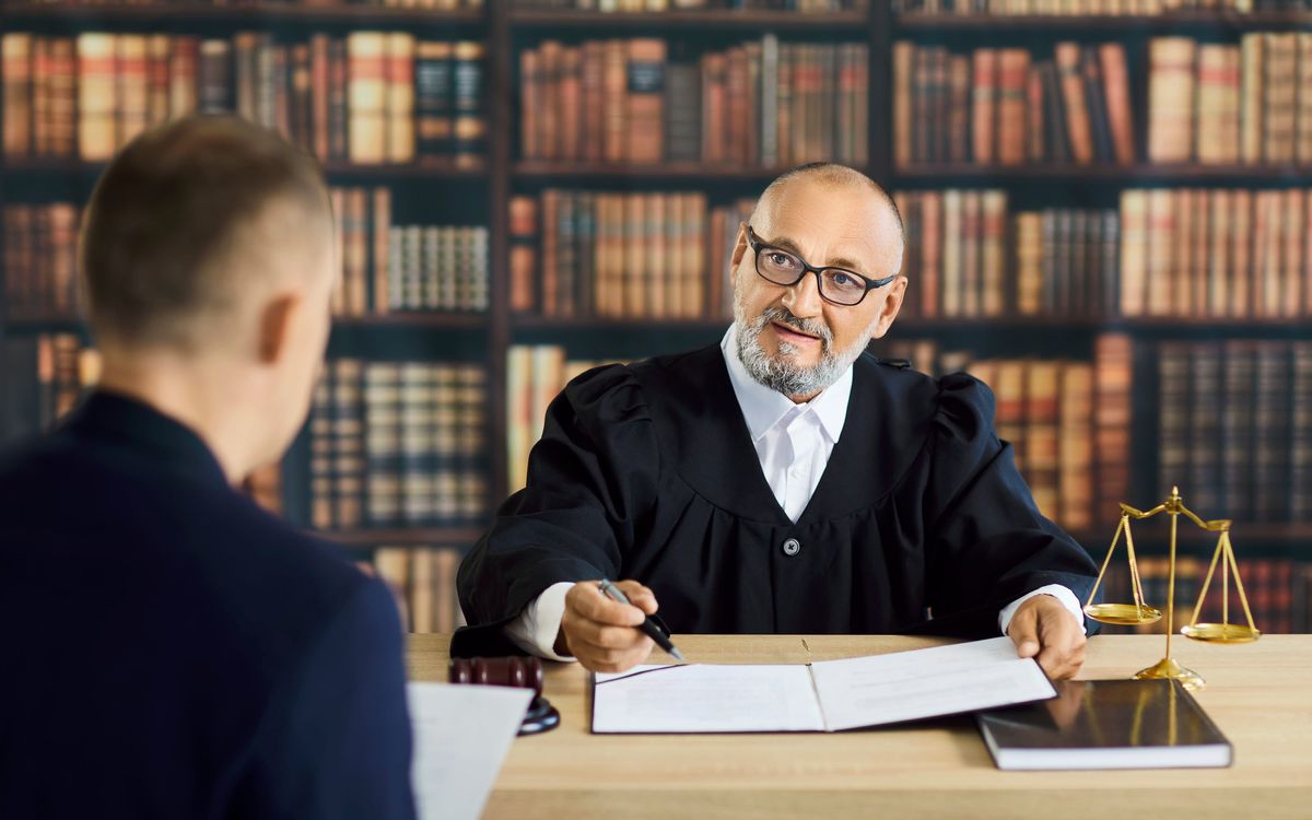 Judge and attorney reviewing a legal document in chambers